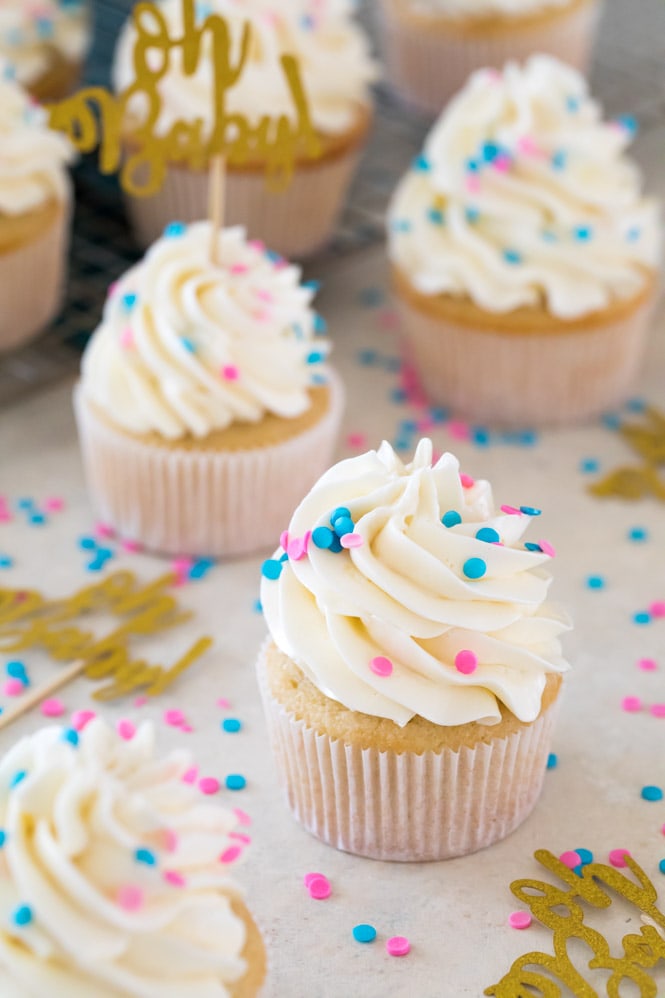 Gender reveal cupcakes: yellow cupcakes with swiss meringue buttercream frosting and blue and pink sprinkles