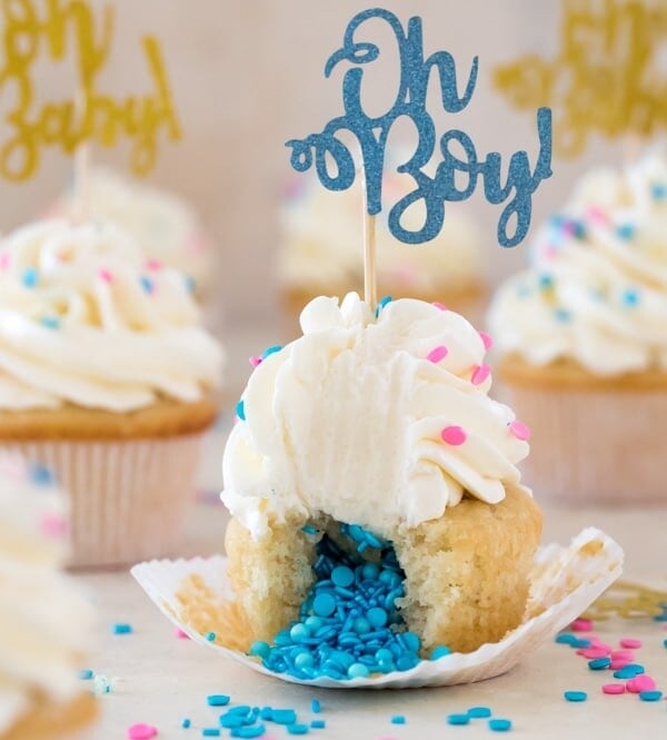 Cupcake broken open to reveal insides topped with frosting and "oh Boy!" decoration