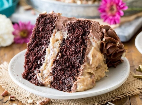 Slice of german chocolate cake on white plate