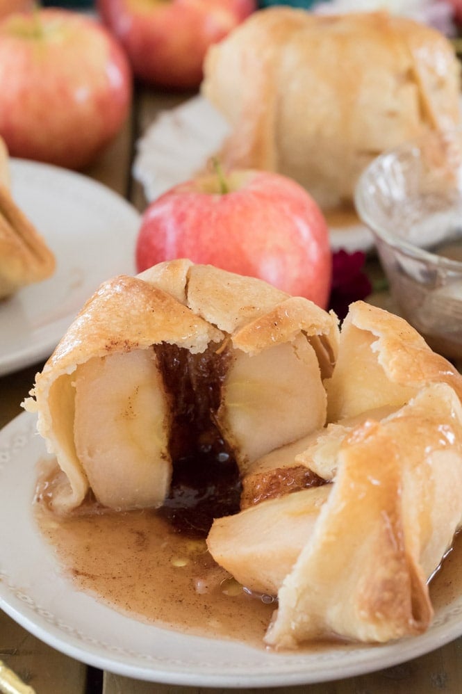 Apple dumpling cut in half to show juicy syrup-filled center