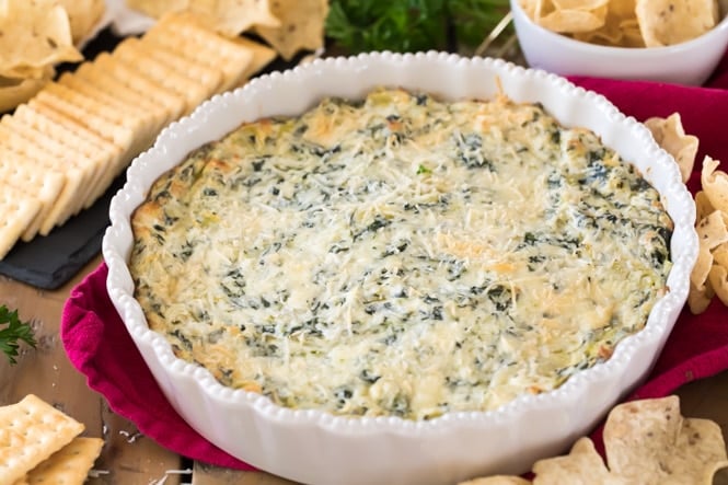 Freshly baked spinach artichoke dip in pie plate