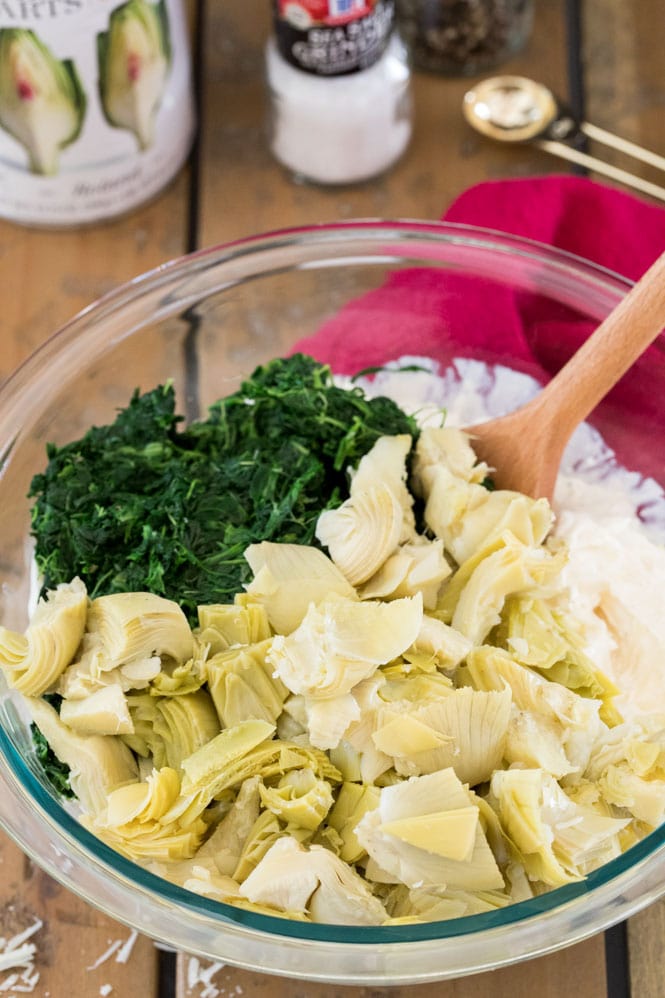 Combining all spinach artichoke dip ingredients in large mixing bowl