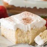 Tres leches cake with fork on white plate