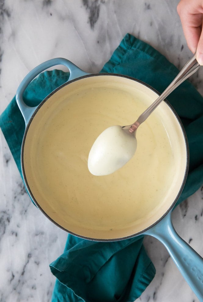 Making vanilla pudding: testing consistency on the back of a spoon