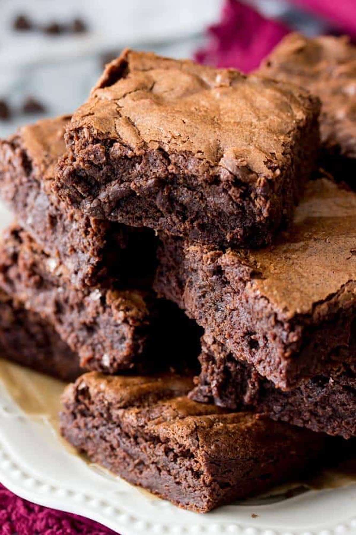 stack of brownies on a white plate