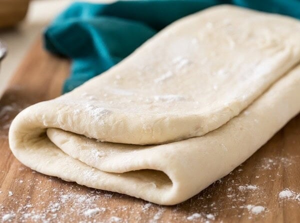 folded puff pastry dough on cutting board