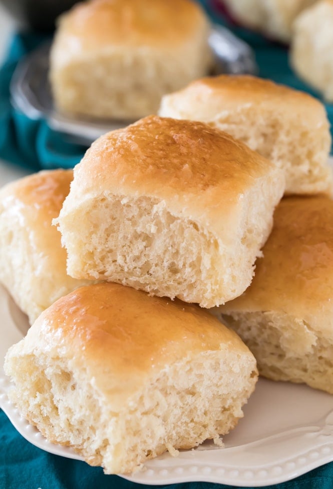 Soft fluffy dinner rolls on a white plate