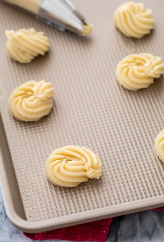 Butter cookies piped onto ungreased baking sheet with Ateco 827 tip