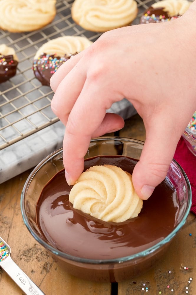 Dipping a butter cookie in melted chocolate