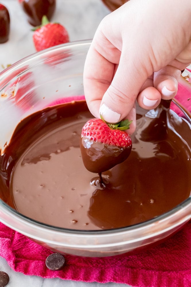 Dipping strawberries in chocolate: hold firmly by the stem