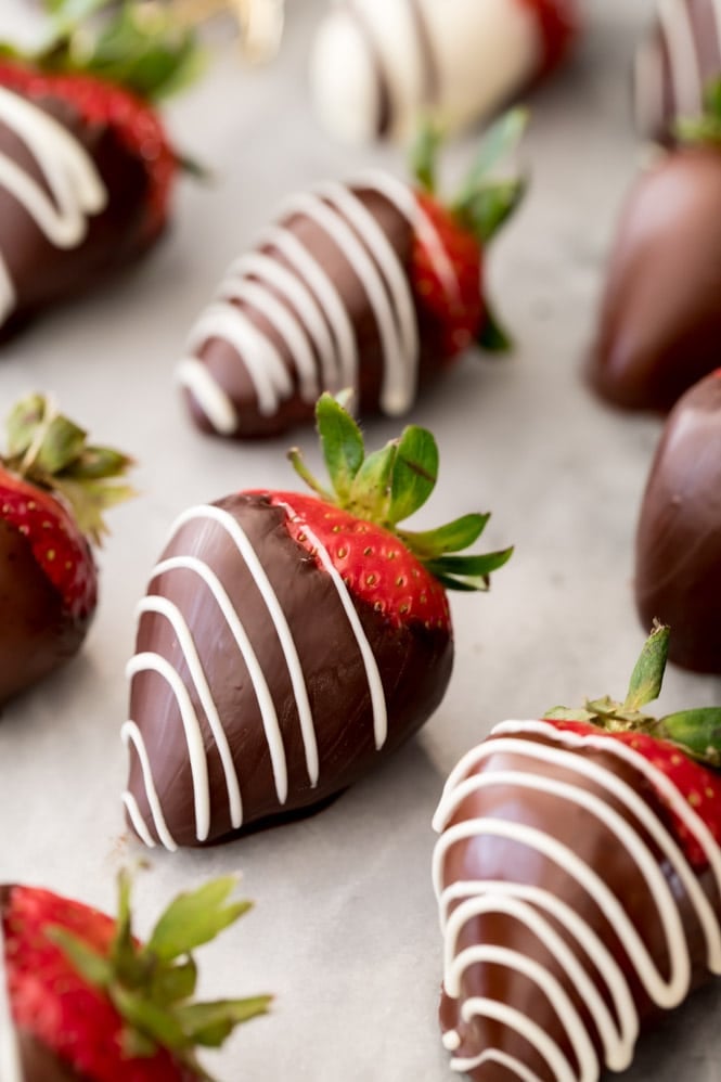 How to make chocolate covered strawberries: beautiful finished berries on white marble