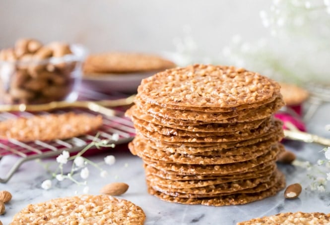 Lace cookies stacked on marble surface