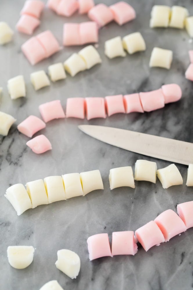 Making butter mints: roll into strips then cut into pieces