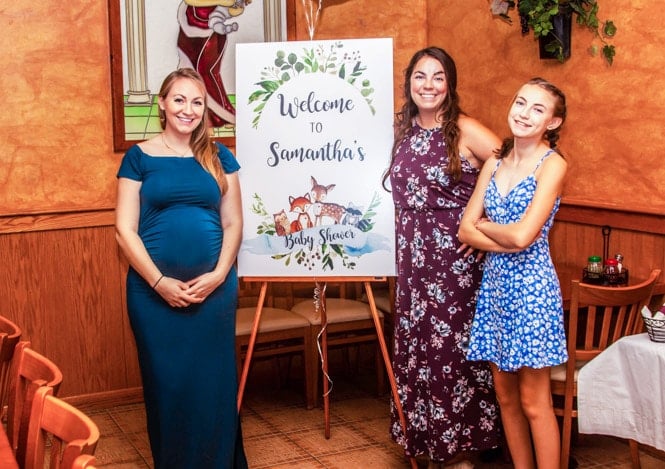 3 women next to sign for baby shower