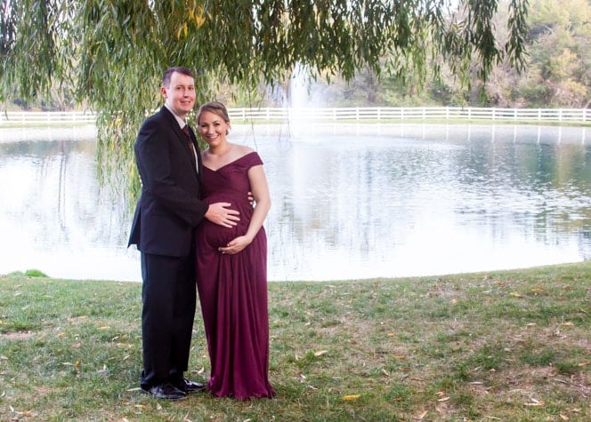 Man and woman standing in front of lake