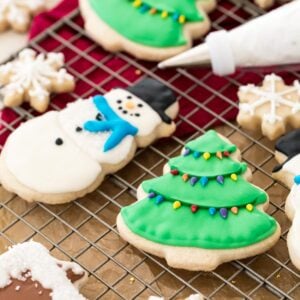 sugar cookies decorated with my easy royal icing recipe on a cooling rack