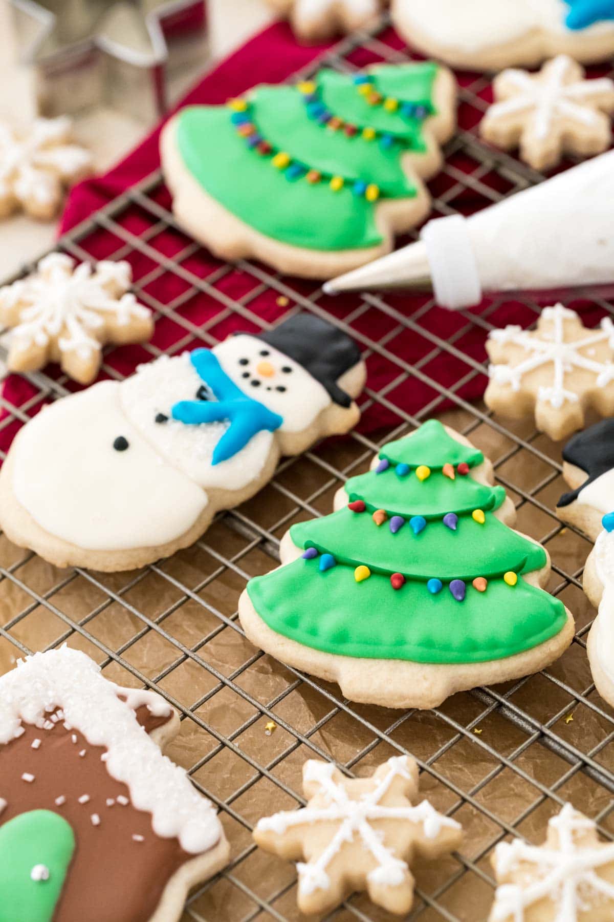 sugar cookies decorated with my easy royal icing recipe on a cooling rack