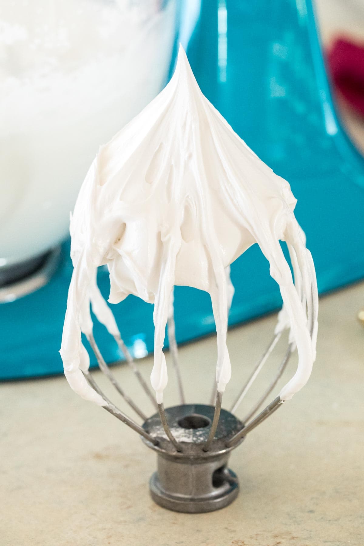 Royal icing whipped to stiff peaks on a whisk beater