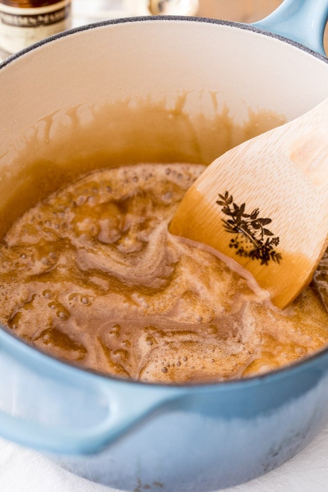 Stirring baking soda and vanilla into caramel for caramel popcorn