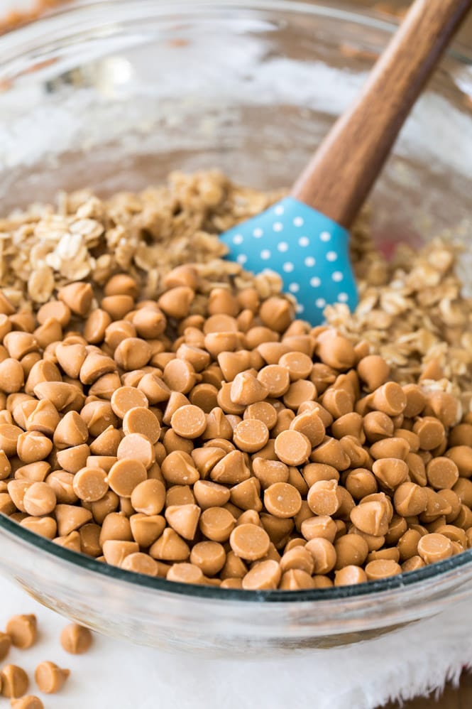 Making cookie dough with butterscotch chips in bowl