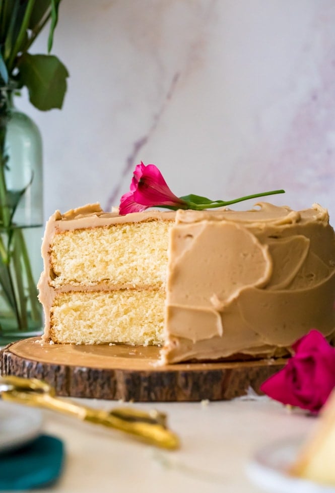 caramel cake on wooden serving platter