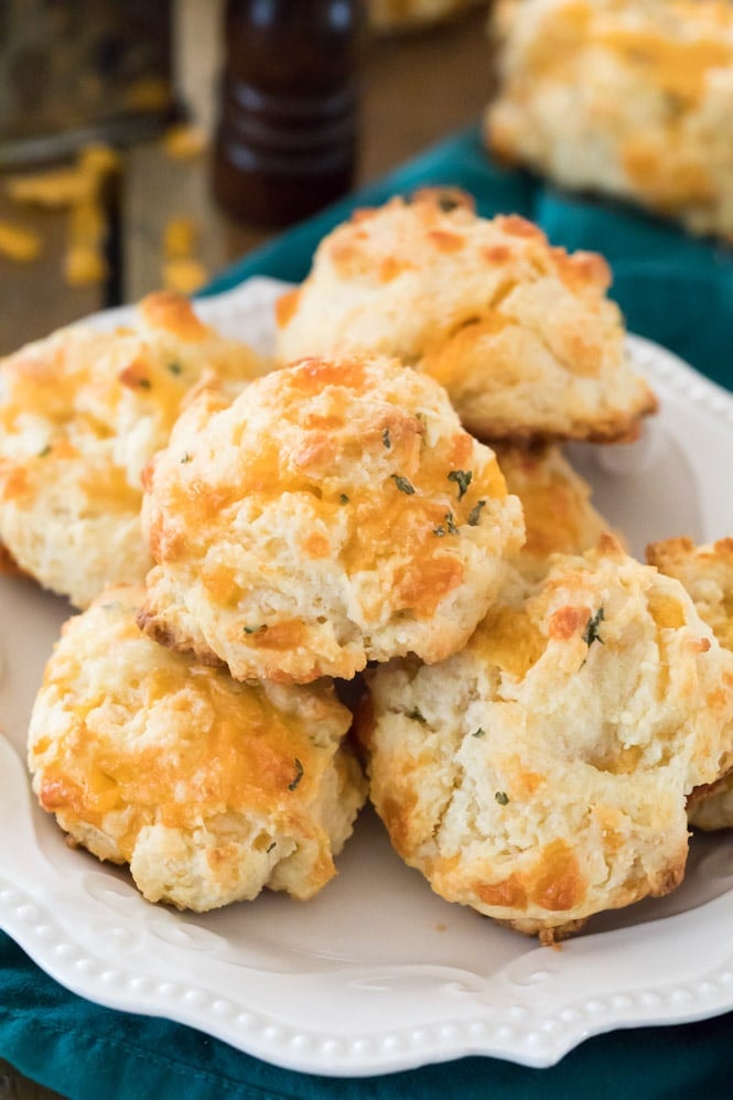 Pile of cheesy drop biscuits on a white plate