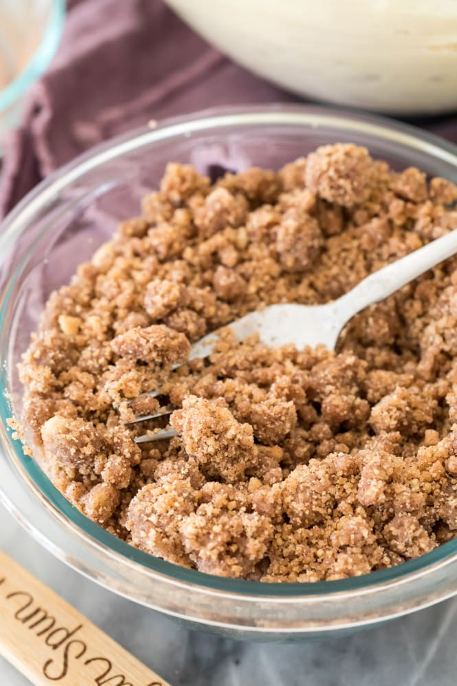 Making streusel topping in a glass bowl with a fork