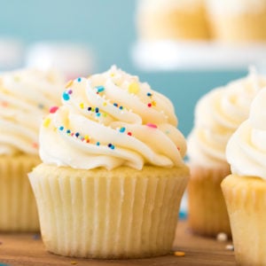 Buttercream frosting topped with sprinkles on vanilla cupcake