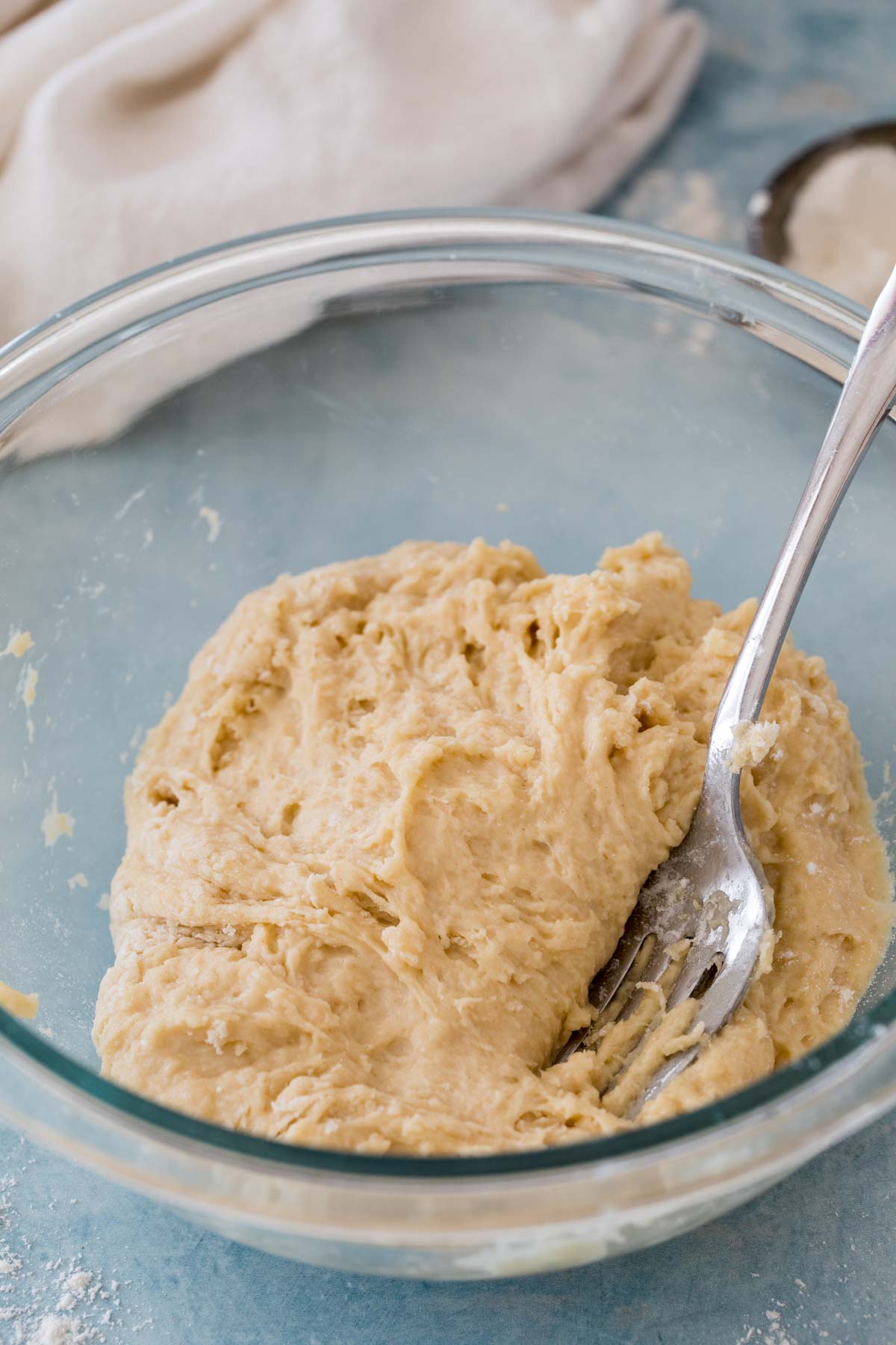 sticky, shaggy dough in glass bowl with fork