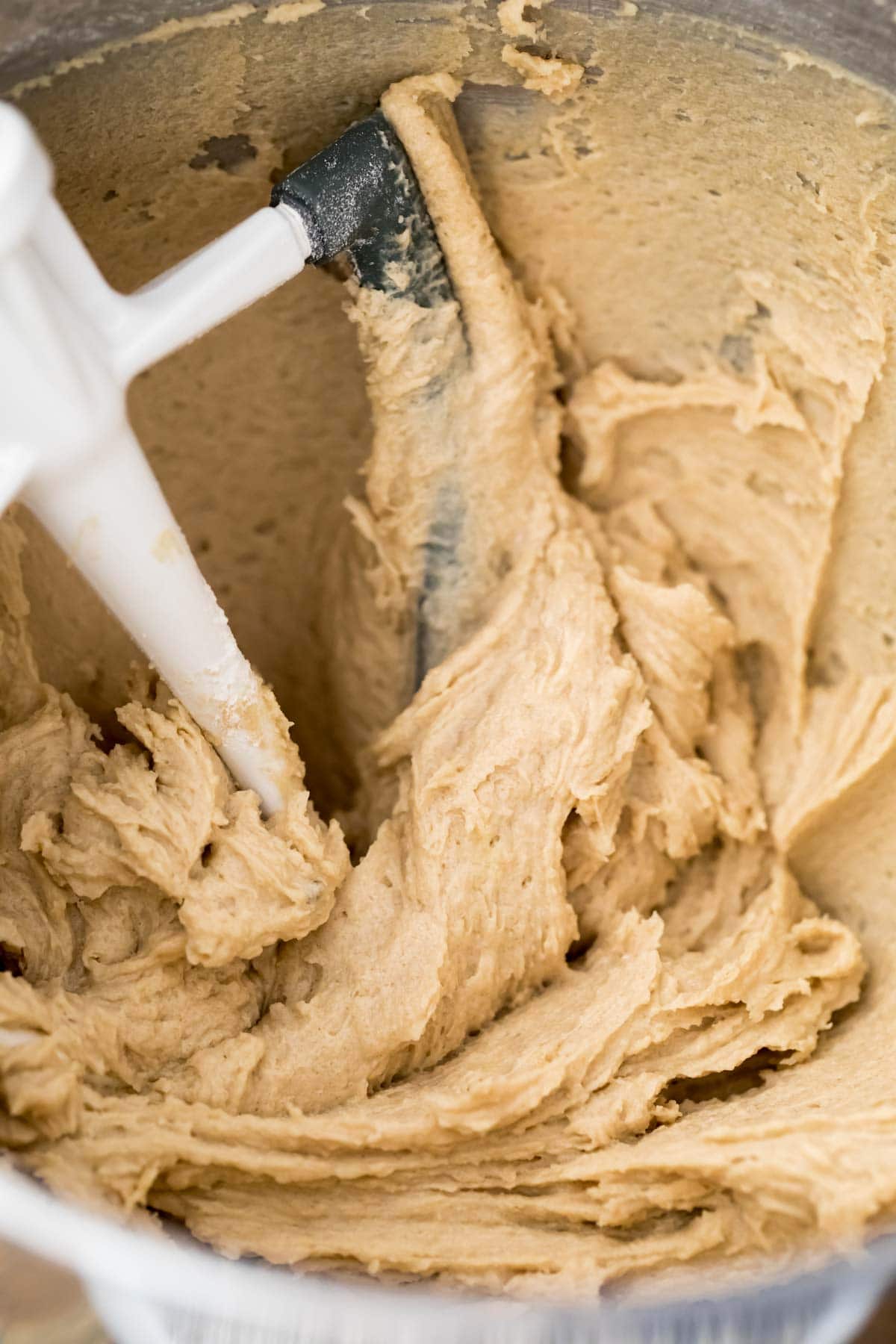 overhead shot of cookie dough frosting in mixing bowl