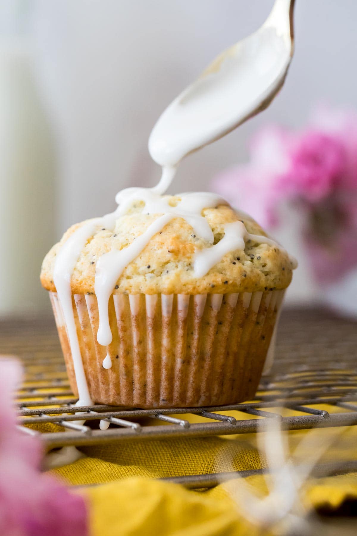 Drizzling icing on lemon poppy seed muffin