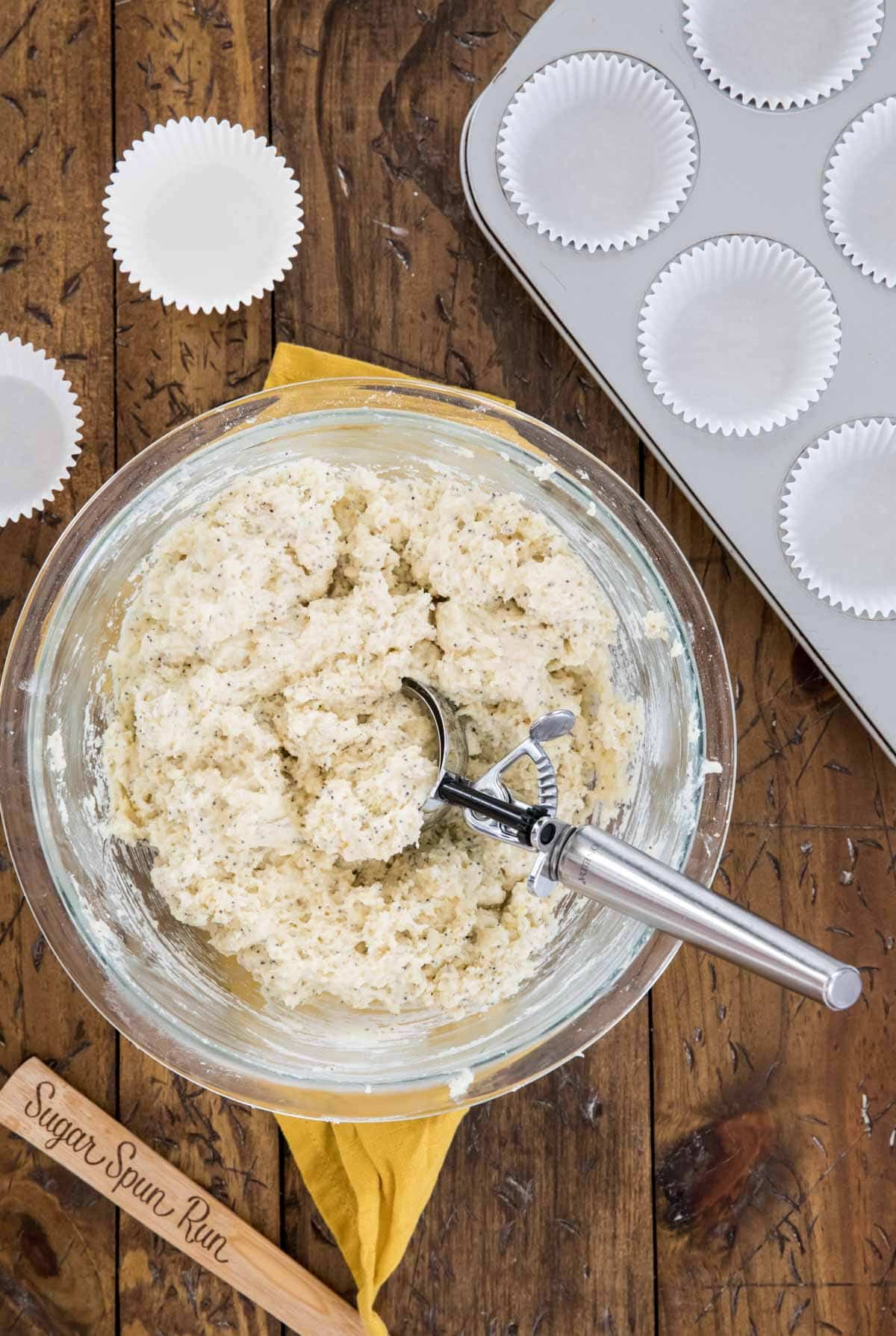 Muffin batter in glass bowl with scoop