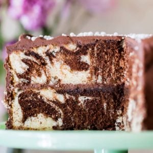 Marble cake on cake platter with slice taken out