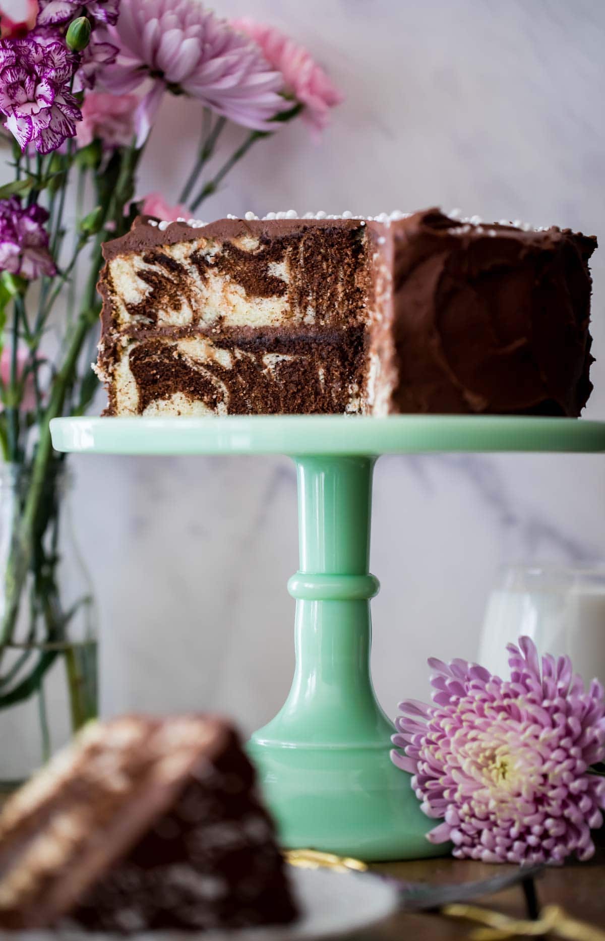 Marble cake on cake platter with slice taken out