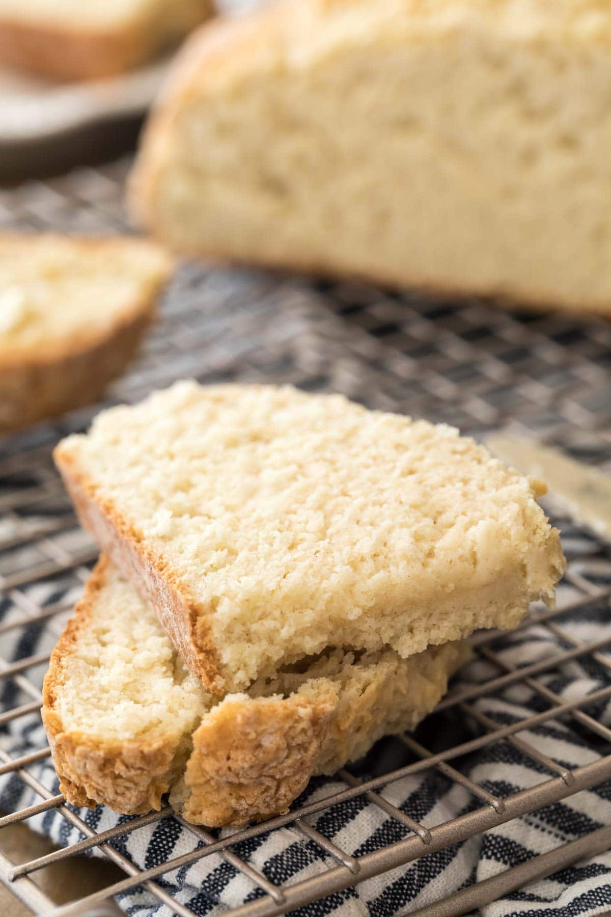 slice of soda bread cut in half on wire cutting rack