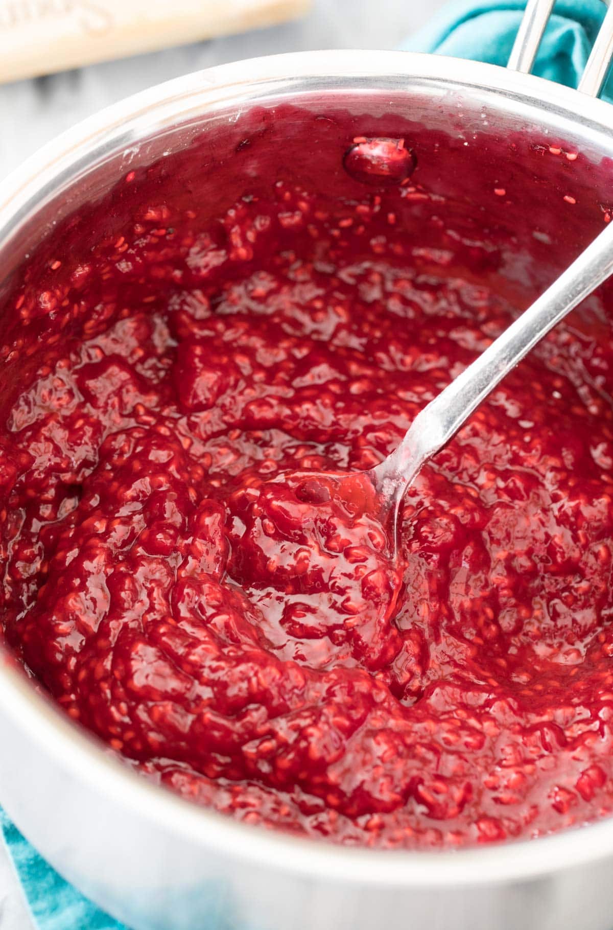 freshly cooked raspberry sauce in saucepan