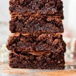 Flourless brownies stacked on marble board