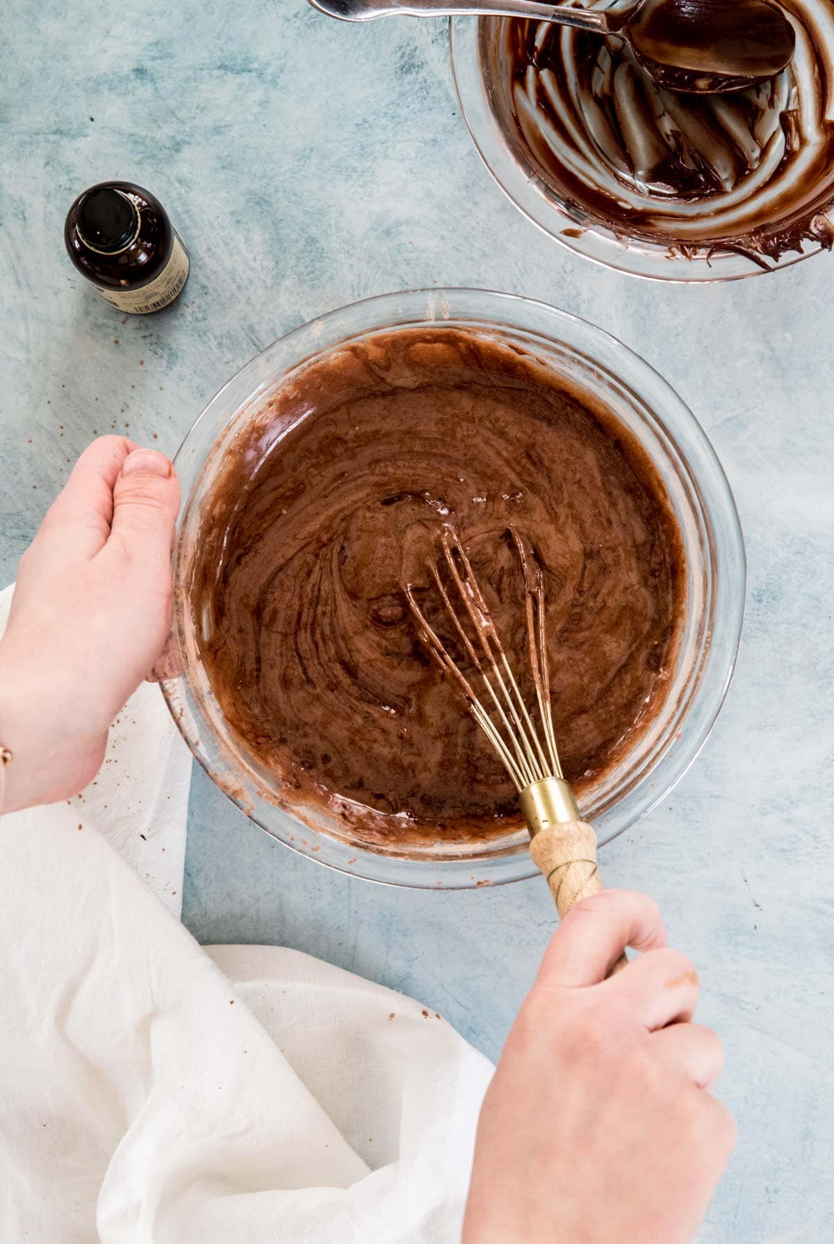 Stirring brownie batter in glass bowl