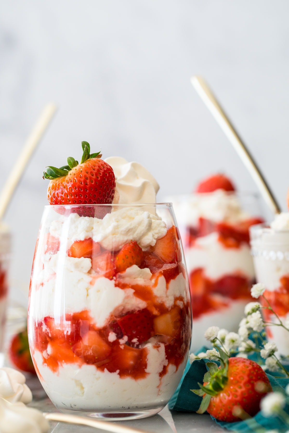 glasses of eton mess (layers of whipped cream/meringue and strawberries)