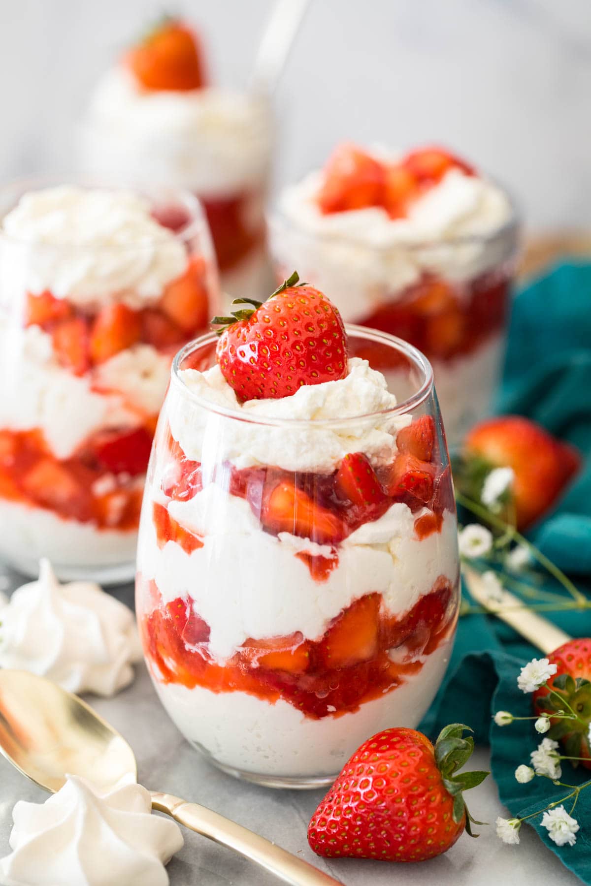 glasses of eton mess (layers of whipped cream/meringue and strawberries)
