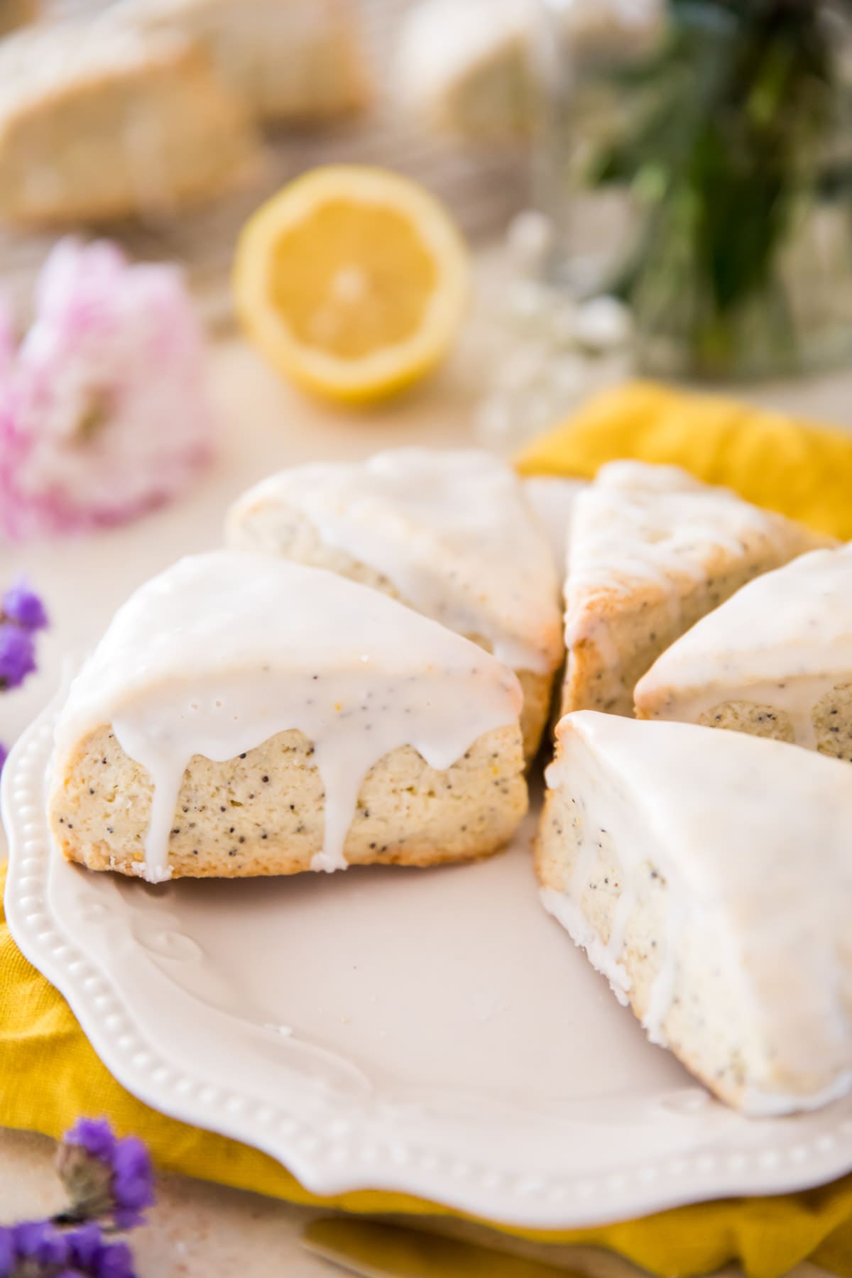 lemon poppy seed scones on white plate with yellow cloth