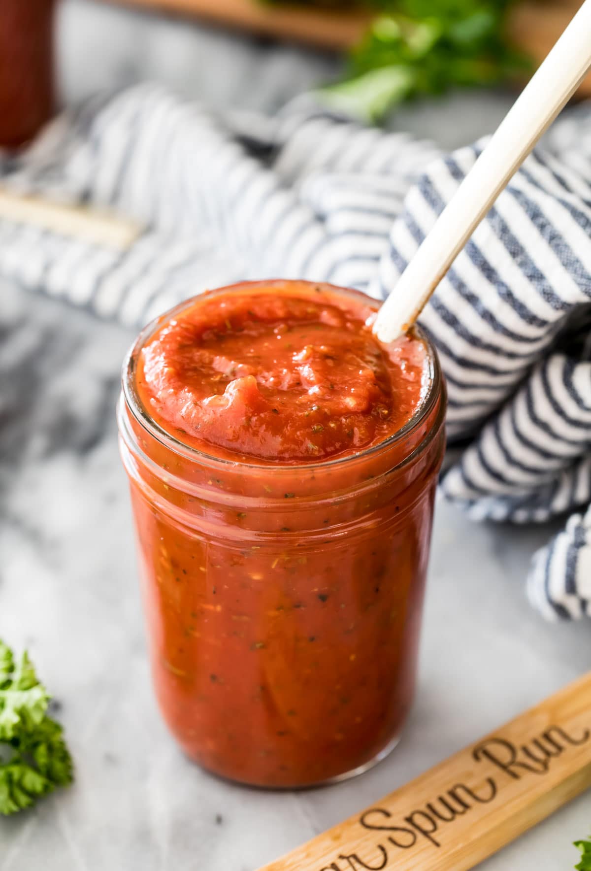 pizza sauce in glass jar with spoon