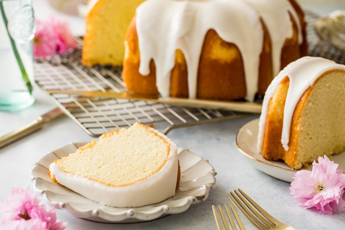 slice of bundt cake on white plate with cake in background