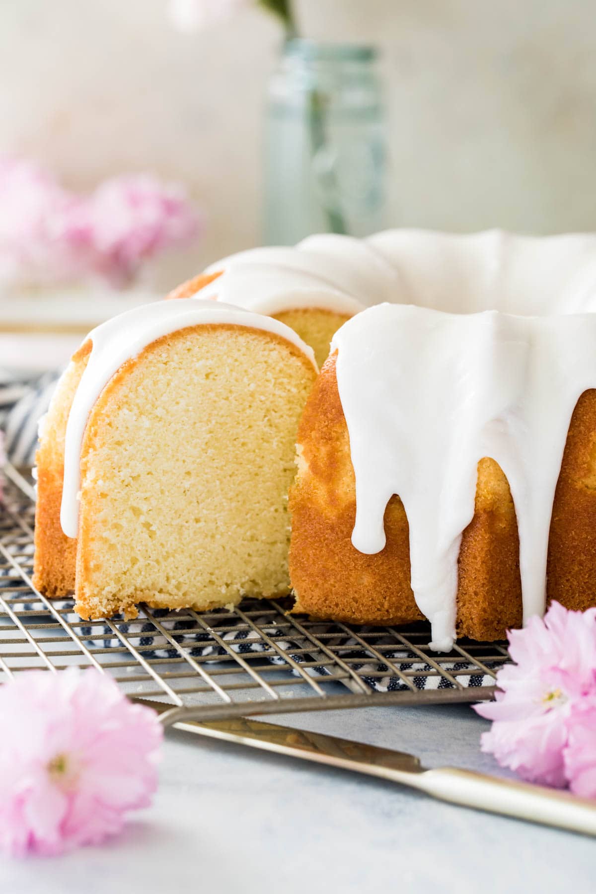 sliced vanilla bundt cake on cooling rack