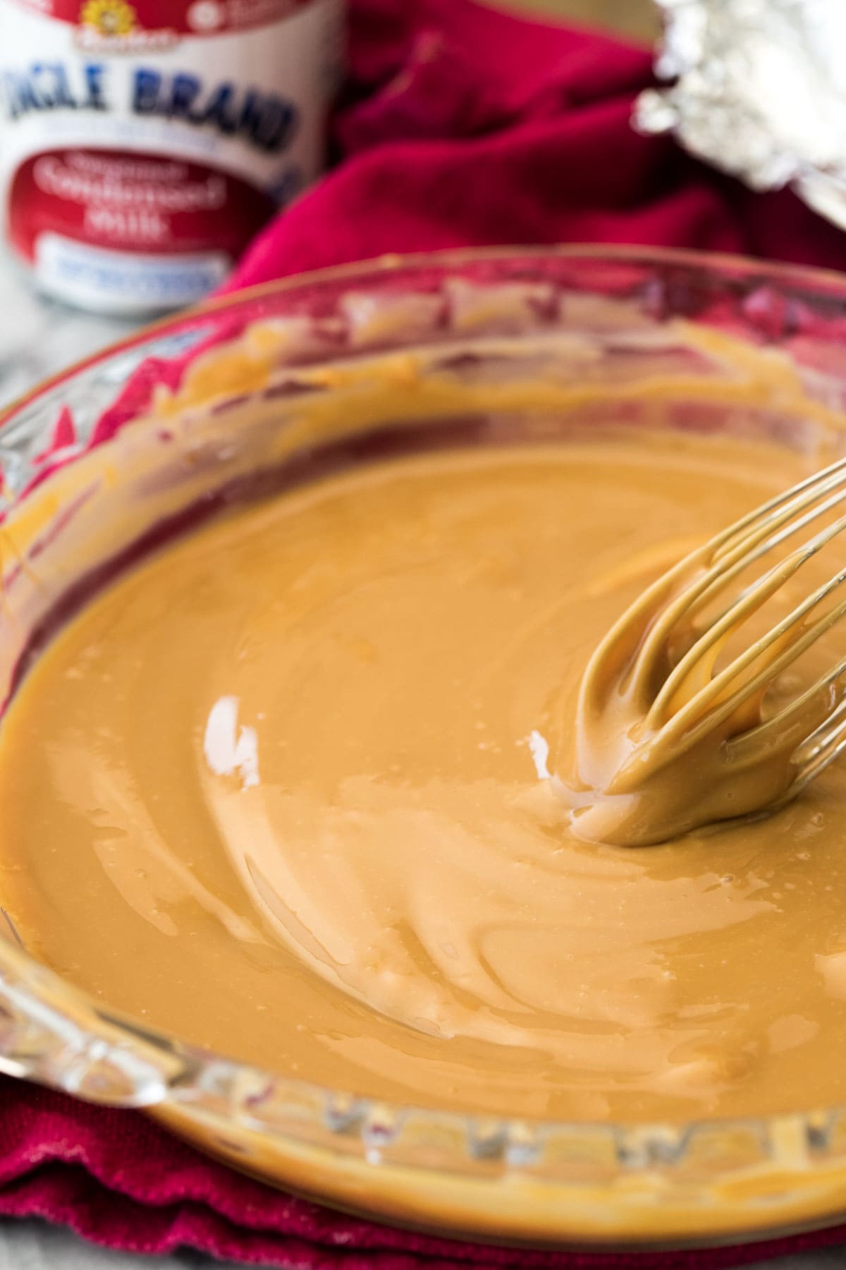 Dulce de leche in pie plate with whisk