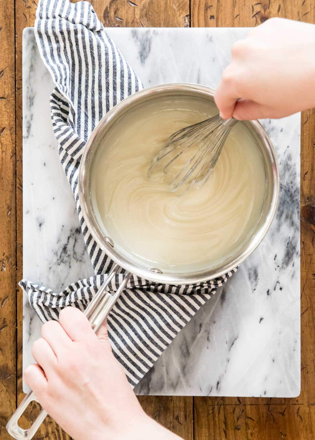 whisking roux in metal saucepan