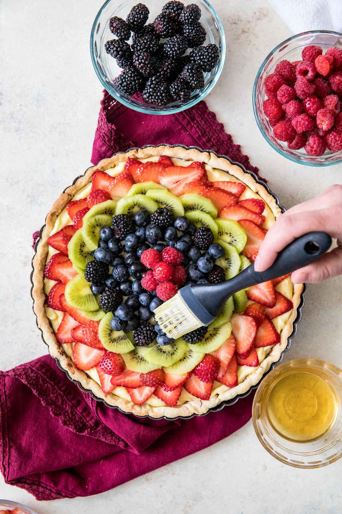 brushing fruit tart with apple jelly