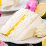 slice of lemon cake with bright yellow curd in the center on white plate