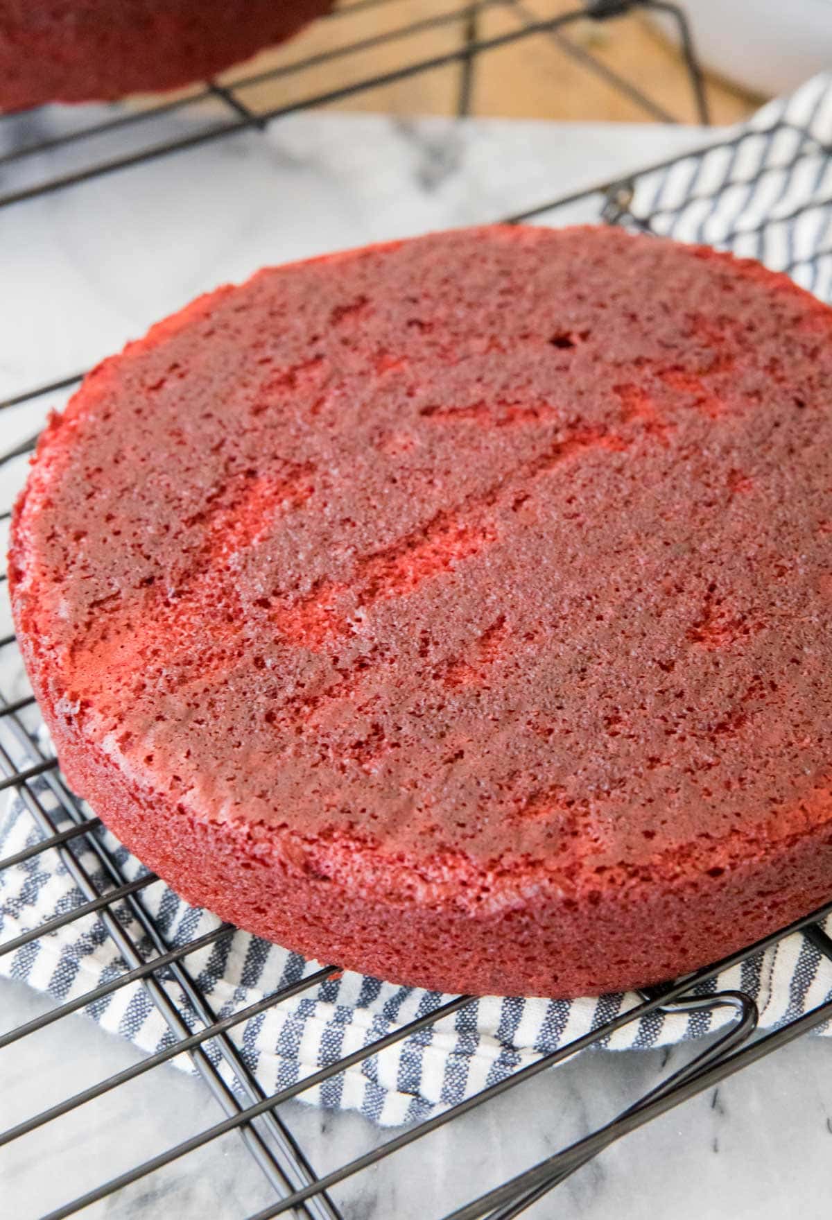 red velvet cake cooling on cooling rack