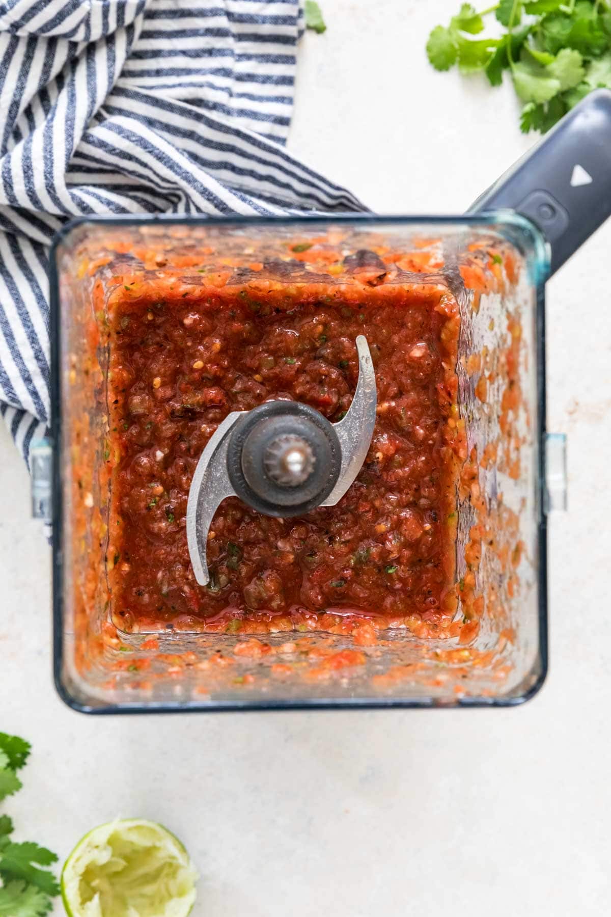 Overhead of blended salsa in blender with blades